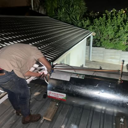 Ariston geyser installation on roof at night